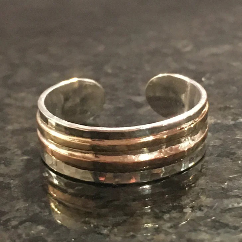 Hammered silver ring with gold bands